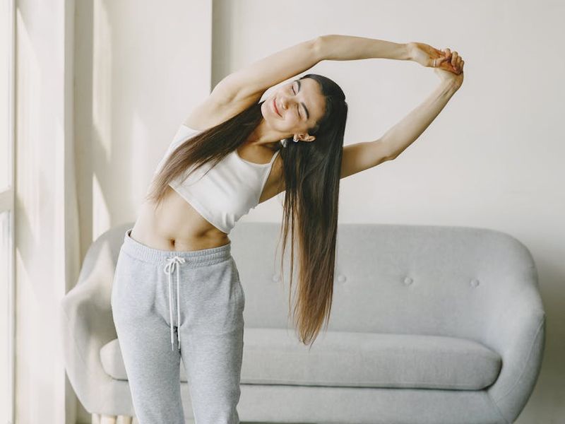 Person doing peaceful stretches in a bright room
